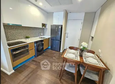Modern kitchen with dining area, featuring sleek appliances and stylish decor, perfect for urban living.