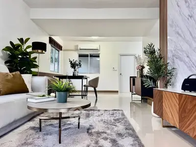 Spacious modern living room with stylish decor and abundant natural light.