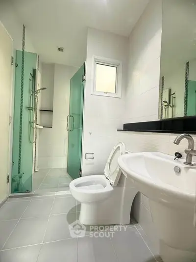 Modern bathroom with sleek fixtures and glass shower enclosure
