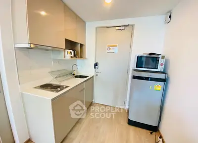 Modern compact kitchen with sleek cabinets and stainless steel appliances