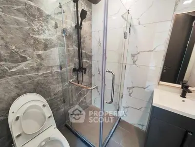 Modern bathroom with glass shower and marble tiles