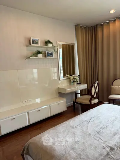 Elegant bedroom with vanity, neutral tones, and stylish decor.