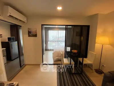 Modern open-plan living room with dining area and bedroom view