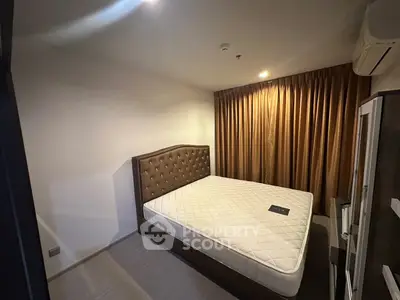Cozy bedroom with elegant brown curtains and a plush headboard, perfect for restful nights.