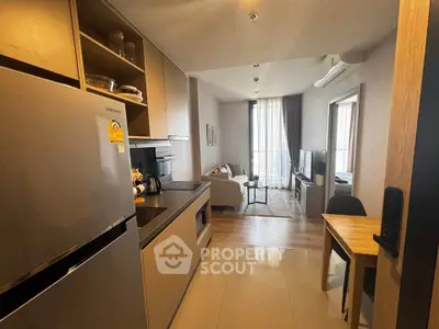 Modern apartment kitchen with open layout leading to cozy living room