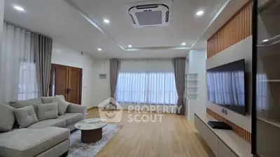 Spacious modern living room with elegant decor and large windows for natural light.