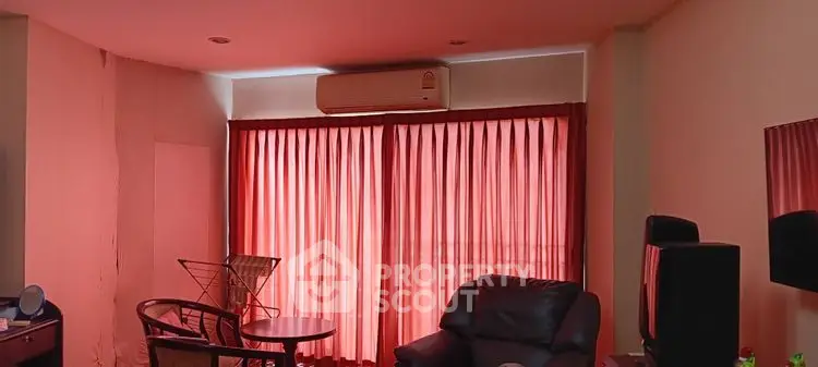 Cozy living room with red curtains and comfortable seating