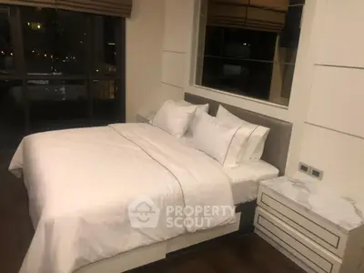 Luxurious bedroom with elegant decor and large window view