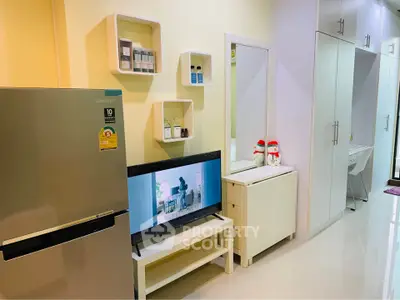 Modern living room with sleek storage and Samsung fridge, perfect for stylish urban living.