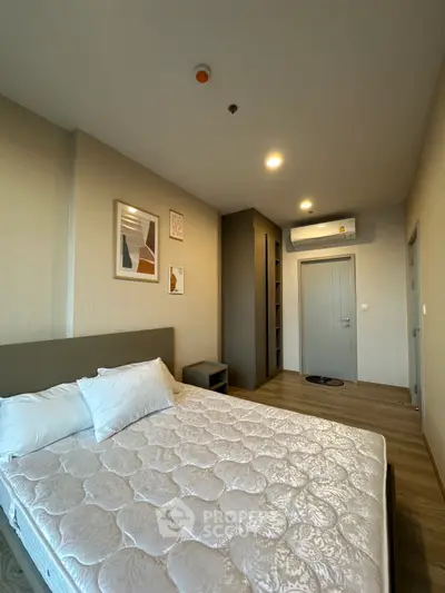 Modern bedroom with stylish decor and air conditioning in a cozy apartment.