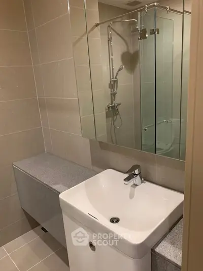 Modern bathroom with sleek fixtures and glass shower enclosure