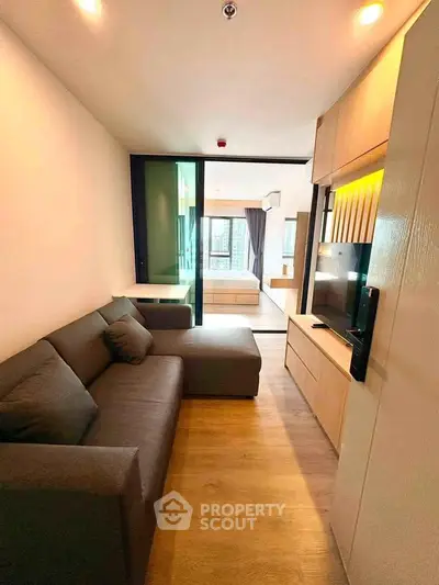 Modern living room with sleek design and cozy ambiance in a stylish apartment.