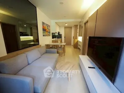 Modern living room with cozy sofa and sleek TV setup in stylish apartment.