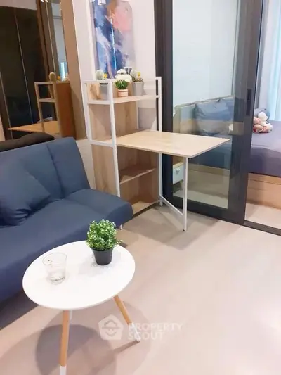 Modern living room with stylish furniture and cozy bedroom view