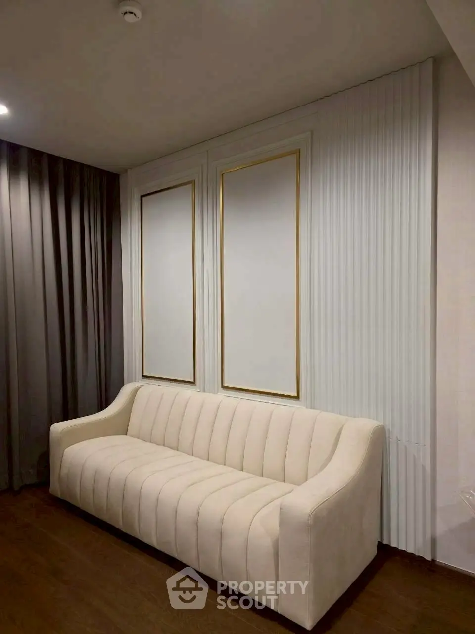 Elegant living room with modern white sofa and stylish wall decor