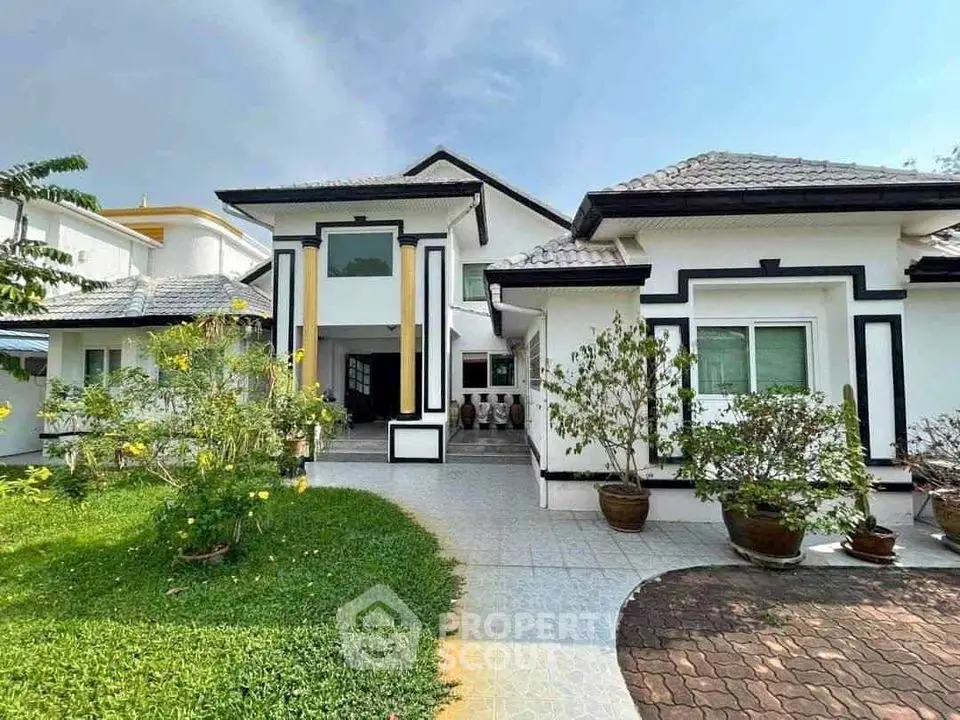 Charming single-story house with lush garden and modern facade