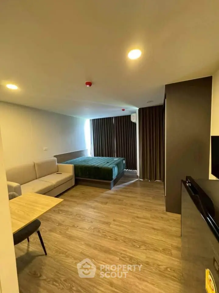Modern studio apartment with cozy living area and stylish decor