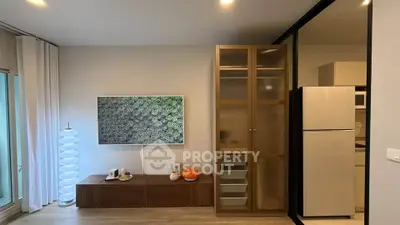 Modern living room with stylish decor and sleek kitchen appliances