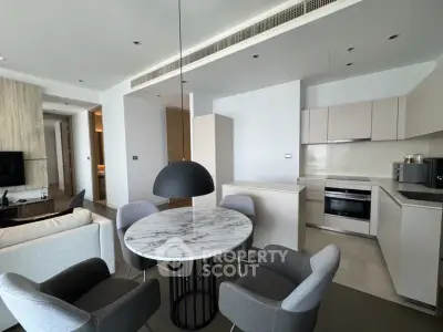 Modern open-plan kitchen and dining area with sleek design and contemporary furniture.