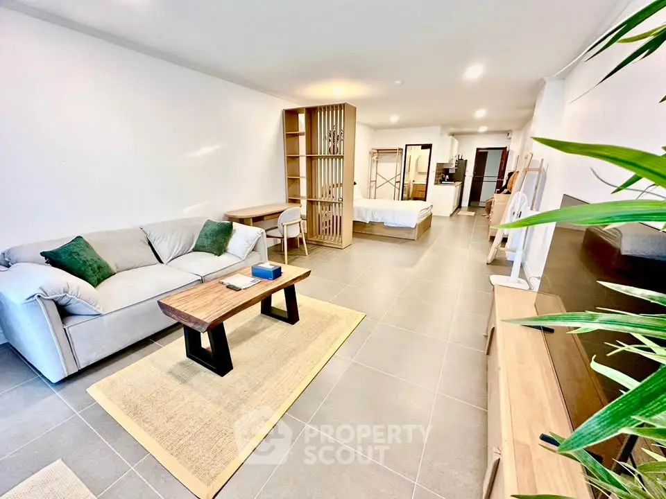 Spacious modern living room with open layout and stylish furnishings in a contemporary apartment.