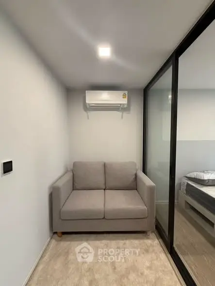 Cozy small living area with modern sofa and air conditioning