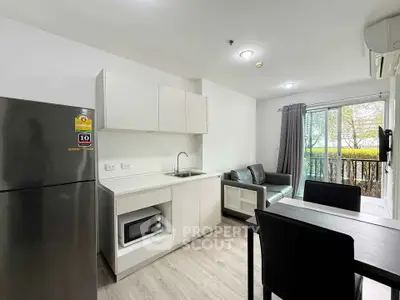 Modern open-layout kitchen and living area with sleek appliances and natural light.