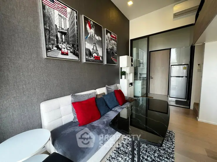 Modern living room with stylish decor and open kitchen layout in a chic apartment.