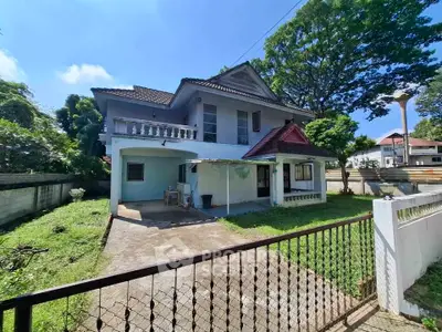 Charming two-story house with spacious garden and driveway in a serene neighborhood.