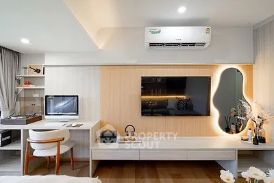 Modern living room with stylish decor and wall-mounted TV