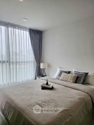 Modern bedroom with large window and elegant decor