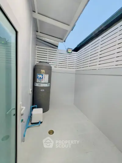 Modern outdoor utility area with water tank and sleek design