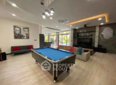 Spacious living room with pool table and modern decor