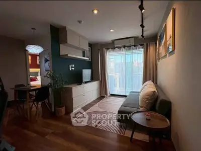 Modern living room with stylish decor and balcony view in a cozy apartment.