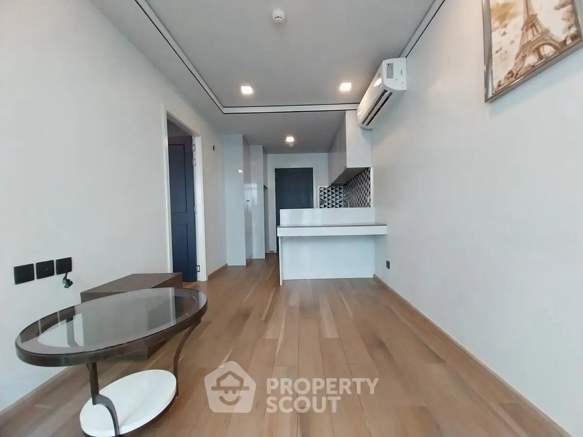 Modern living room with wooden flooring and sleek air conditioning unit