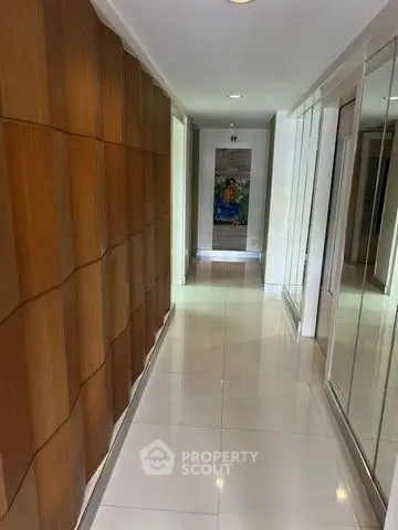 Elegant hallway with modern wooden paneling and glossy tile flooring
