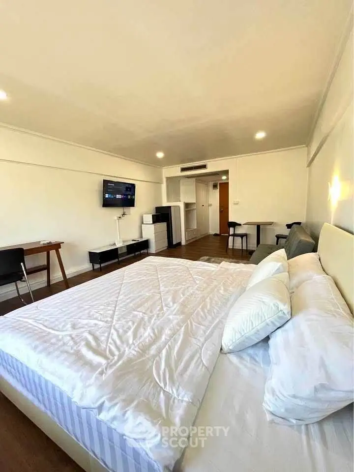 Spacious bedroom with modern furnishings and natural light