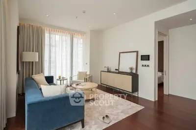 Elegant living room with modern furniture and large windows in luxury apartment.
