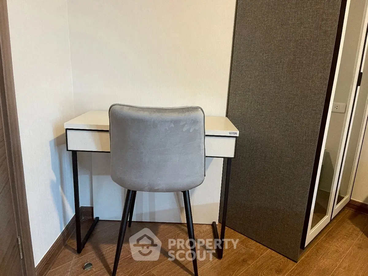 Cozy study nook with modern desk and chair in a compact space.