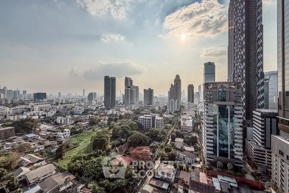 Stunning cityscape view from a high-rise building showcasing urban skyline and lush greenery.