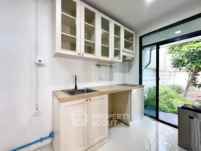 Modern kitchen with sleek cabinetry and garden view