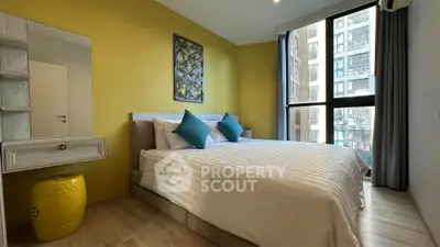 Modern bedroom with large window and stylish decor in urban apartment
