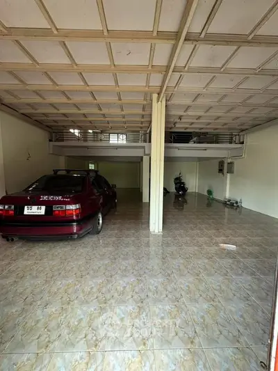 Spacious garage with tiled flooring and ample parking space