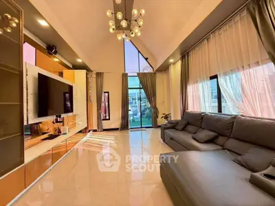 Luxurious living room with modern decor and large windows for natural light.
