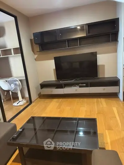 Modern living room with sleek TV unit and glass coffee table