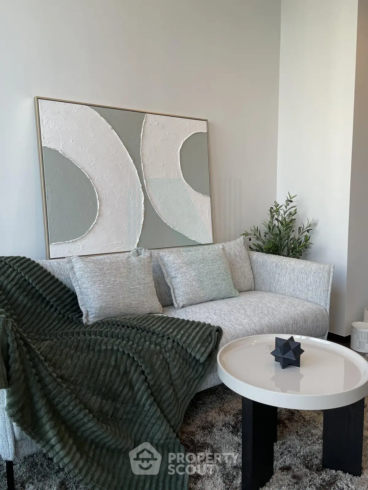 Stylish modern living room with elegant sofa and abstract art, perfect for contemporary urban living.