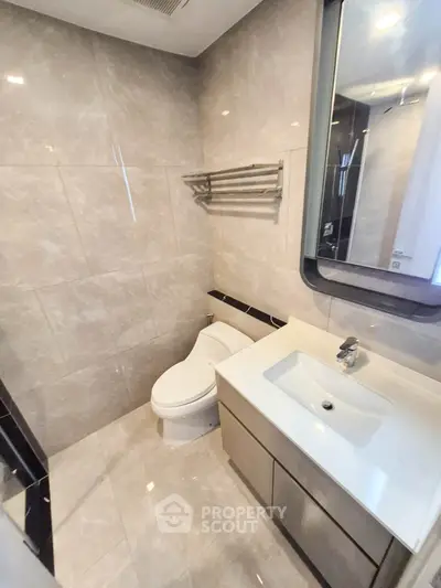Modern bathroom with sleek fixtures and elegant tile design.