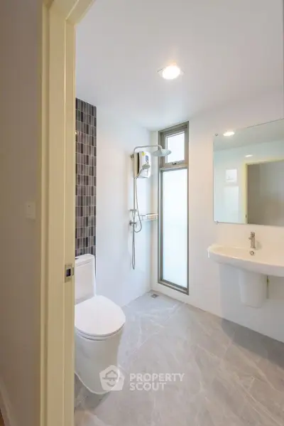Modern bathroom with sleek design and large mirror in a contemporary home.