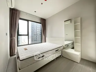 Modern bedroom with city view, featuring a sleek design and ample natural light.