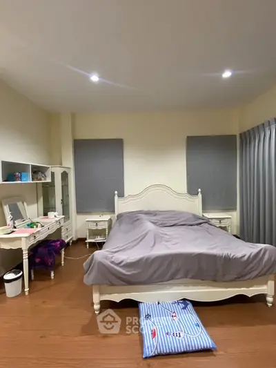 Cozy bedroom with elegant furniture and soft lighting, perfect for relaxation.