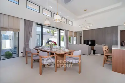 Spacious modern living room with elegant dining area and large windows for natural light.